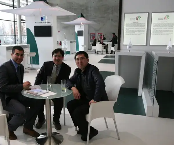 Visitors gathered around an exhibition table