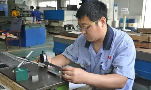 Technician measuring a component at a workbench