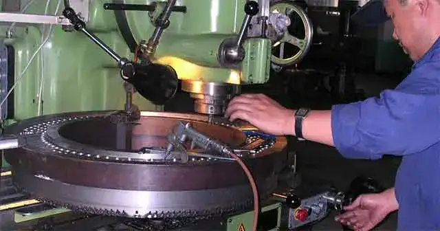 xc-2 Technician working on a circular metal component
