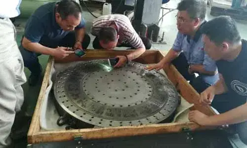 Participants inspecting a die plate together