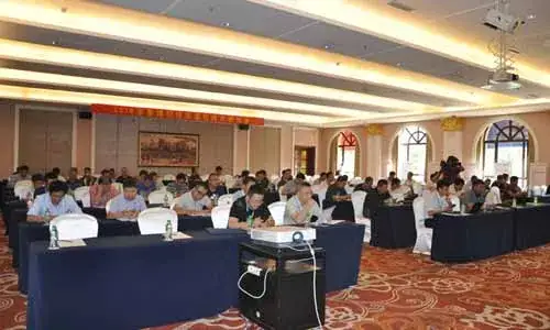 Conference speakers seated behind a long table
